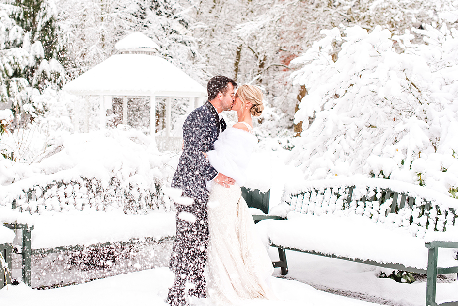 Jordan and Jenna Schiemer kiss in the snow.